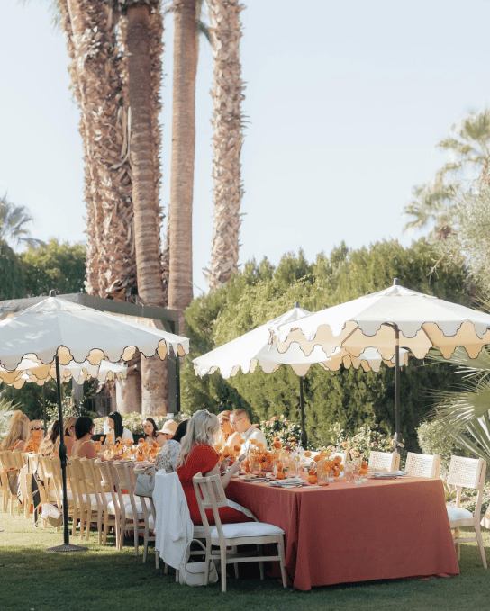 Coral linens and citrus-toned tabletop styling for a Palm Springs wedding welcome brunch