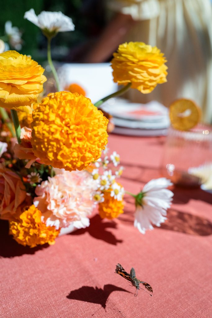 Close-up of ranunculus and cosmos in an autumn palette for a vibrant floral design
